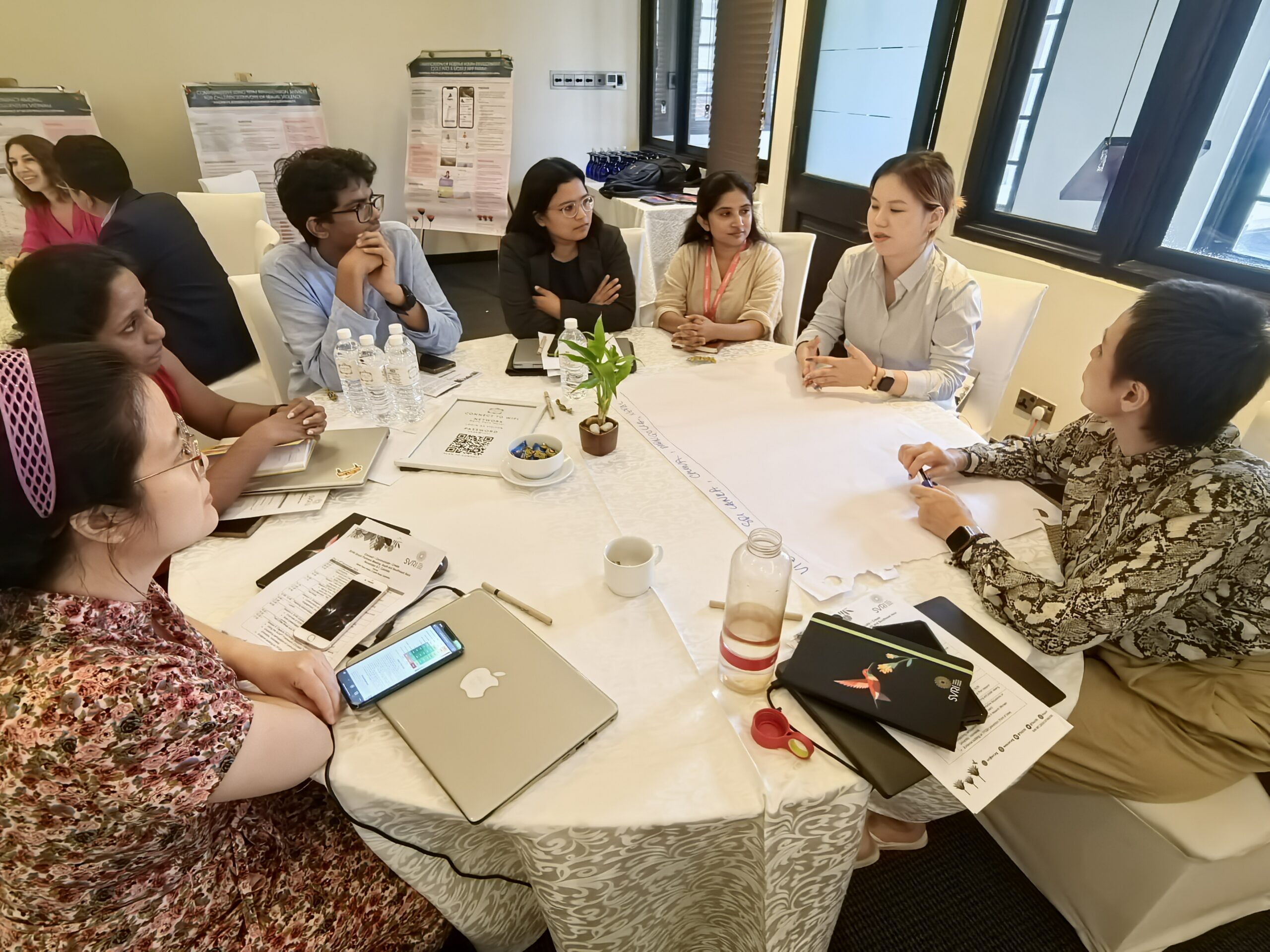 SVRI Grant Partners Meeting in Sri Lanka -women researchers around a table.